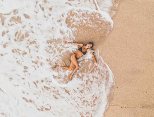 woman lying on the beach in the sea